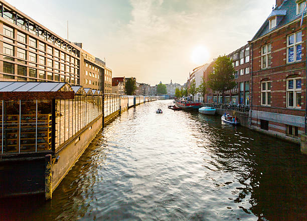 istock Typical Dutch canal located behind the flower market in Amsterdam. 587550310