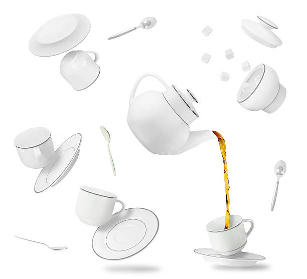 falling tea cups, saucers and pot Set of flying and falling tea cups, saucers and pot isolated on white background. Gravity concept tea cup and saucer stock pictures, royalty-free photos & images