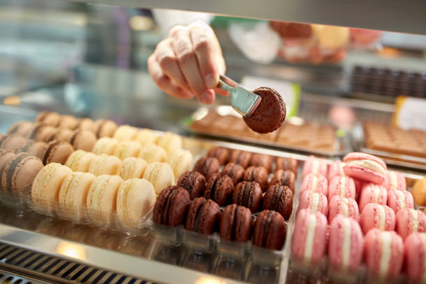 istock Close up taking  chocolate macaron from showcase 587772798