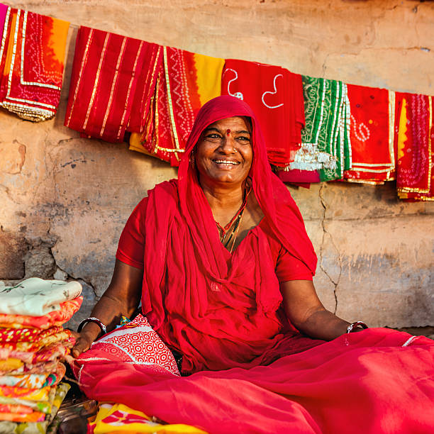 istock Indian woman selling colorful fabrics 587773254
