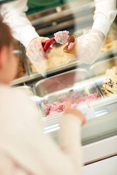 istock Vendor's hands putting ice cream in cone 587775376