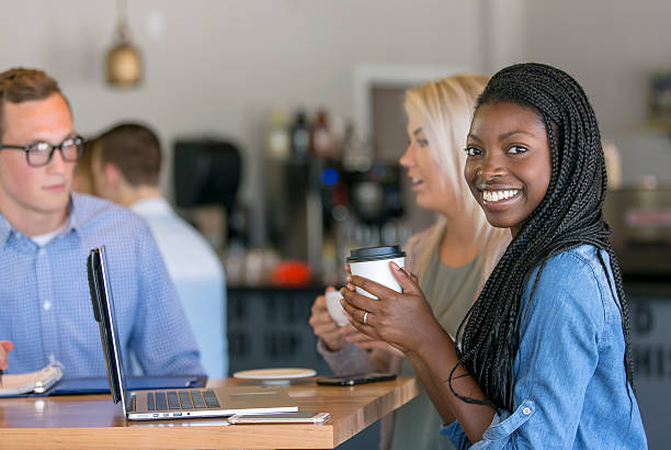 istock African american young woman drinking coffee while 587775656