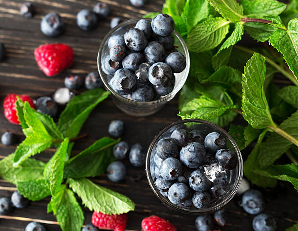 istock Blueberries, raspberries and mint at black wooden table. 587776214