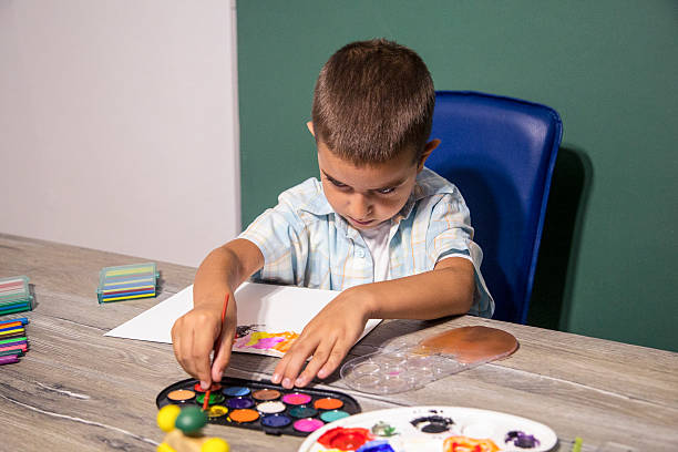 istock Small child painting with watercolors. 587777088
