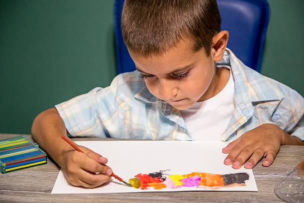 istock Small child painting with watercolors. 587777156