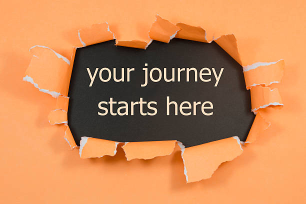 istock your journey starts here written under torn paper 587777404