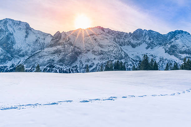 istock Sun shining over mountain peaks and snow 587777686