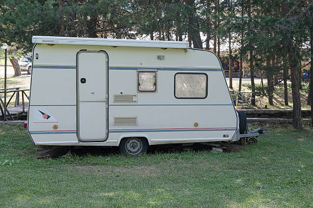 istock Caravan trailer camping on a green lawn 587778134