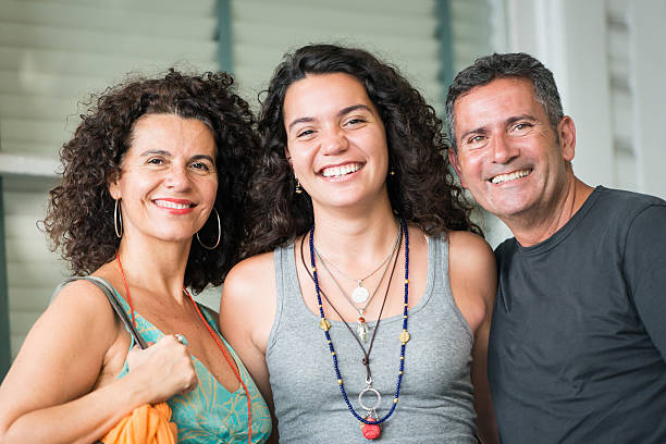 Happy Family Very Happy parents posing with their daughter college student and parent stock pictures, royalty-free photos & images