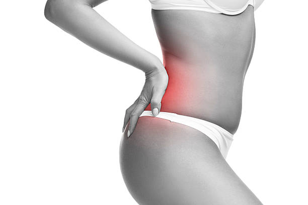 istock Woman in underwear with backache isolated on white 587778416