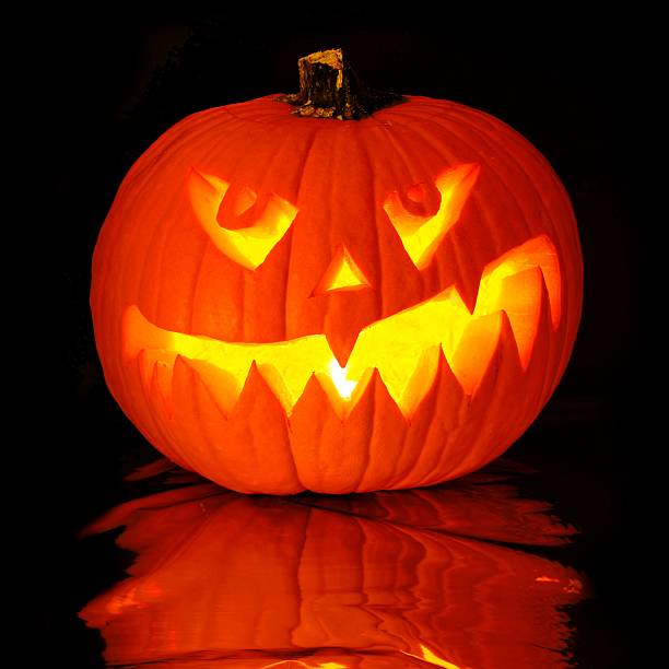 Halloween Jack o Lantern with reflection on black background