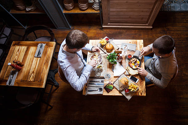 istock Young men eating out in cafe or restaurant 587780142
