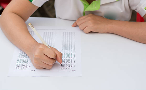 woman's hands filling in standardized test form