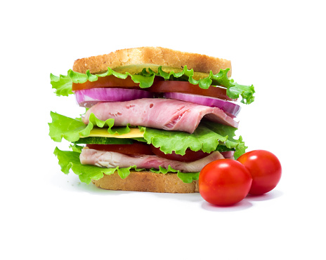 Double sandwich of bread, ham, cheese, tomato, cucumber, onion and lettuce and its ingredients isolated on white background.
