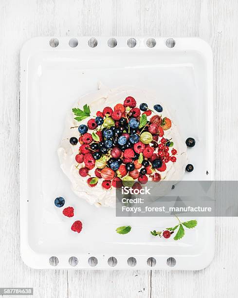 Homemade Pavlova Cake With Fresh Garden Berries On White Baking Stock Photo - Download Image Now