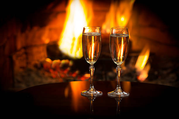 istock Sparkling wine in front of warm fireplace. Romantic, cozy atmosphere 587786156