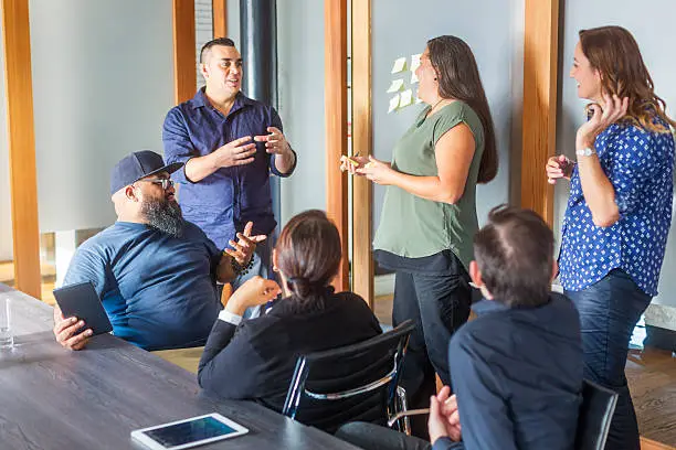 Successful Maori Pacific Islander business woman leading a team of start up entrepreneurs in a corporate business meeting in New Zealand
