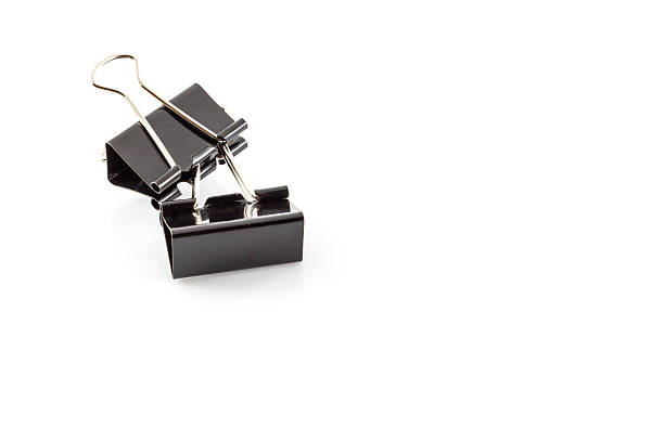 istock Black metal paperclips on white 587788020