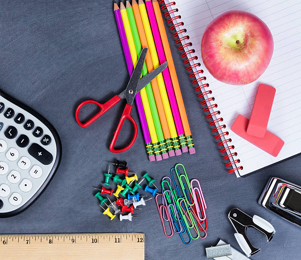 istock Basic back to school supplies placed on erased black chalkboard 587790106