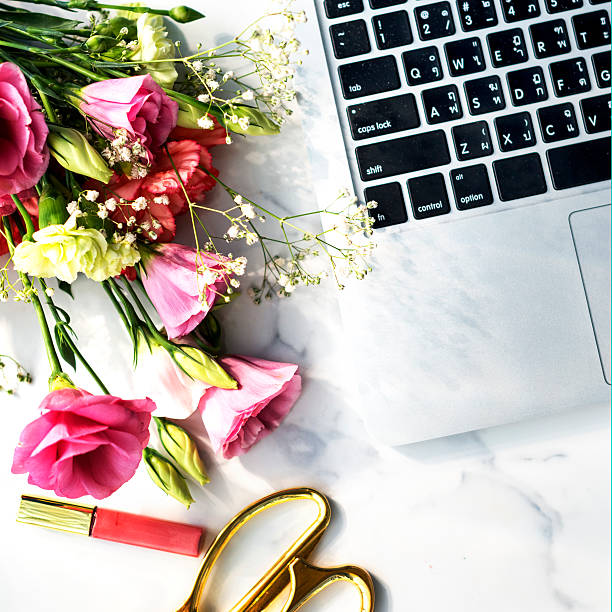 istock Flowers Lipgloss Laptop Desk Concept 587790550