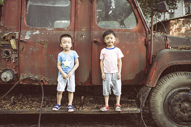 Children and old car wreck