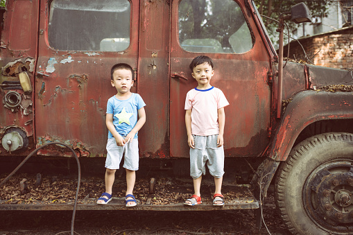 Children and old car wreck