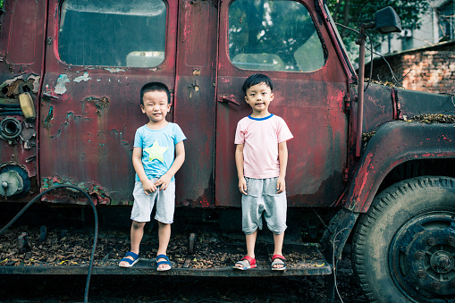 Children and old car wreck