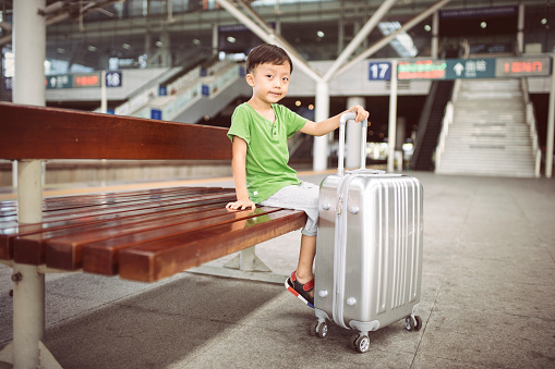 The little boy was waiting at the airport 