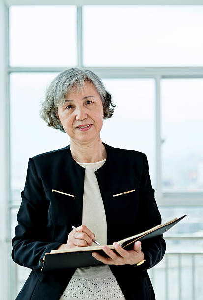 istock Senior businesswoman working in modern office 587796580