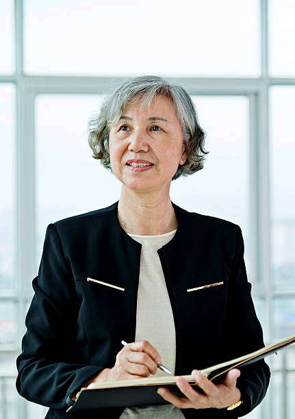 istock Senior businesswoman working in modern office 587796616