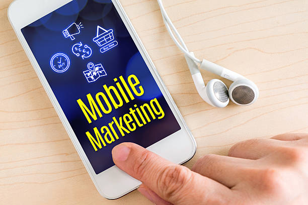 istock Hand touch smart phone and ear phone with Mobile marketing 587797336