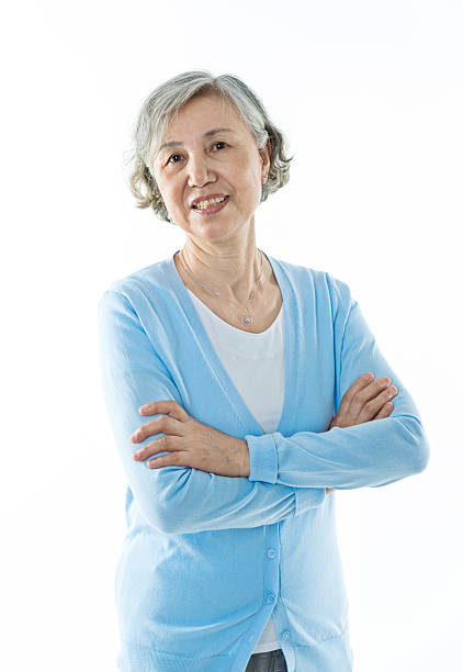 istock Beautiful senior woman smiling against white background 587797506