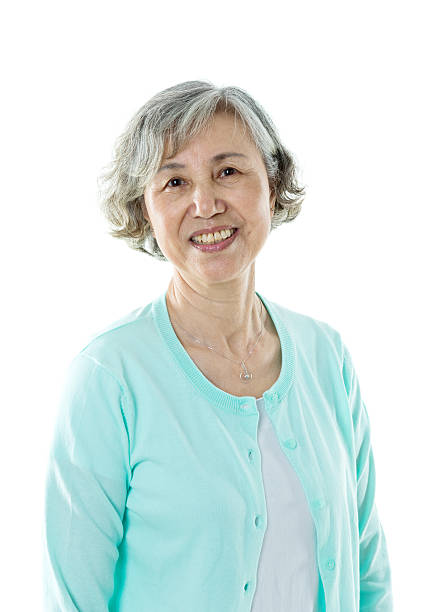 istock Beautiful senior woman smiling against white background 587797664