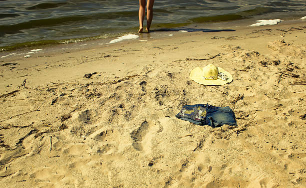 istock The hat and shorts lying on the sand at the 587800052
