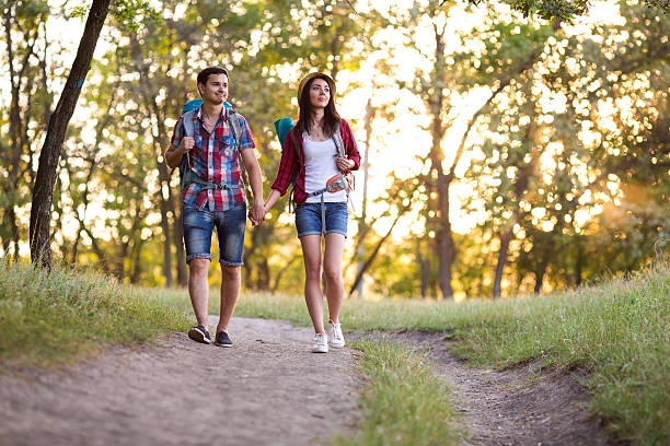 istock Two Hikers Man and Girl walking on Trail in Forest 587800984