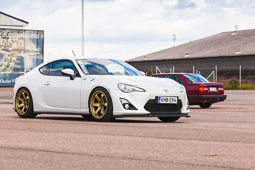 Kotka, Finland - July 16, 2016: White Toyota GT86 goes down the street in European town. The 86 is a series of sports cars jointly developed by Subaru and Toyota