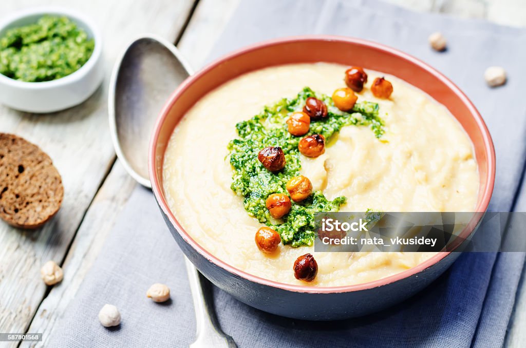 cauliflower chickpea soup with cilantro pesto and roasted chickpeas cauliflower chickpea soup with cilantro pesto and roasted chickpeas. toning. selective focus Pesto Sauce Stock Photo