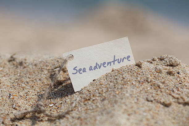 Message Sea adventure on the sand stock photo