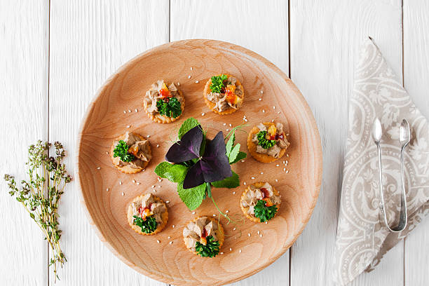 Foie gras plate on white wooden background Foie gras plate on white wooden background, flat lay. Delicious french delicatessen on crackers, served on catering board. Wedding, celebration, luxury expensive food foie gras stock pictures, royalty-free photos & images