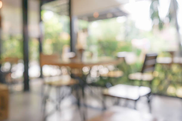 istock Abstract blur desk and chairs in coffee shop background 587804334