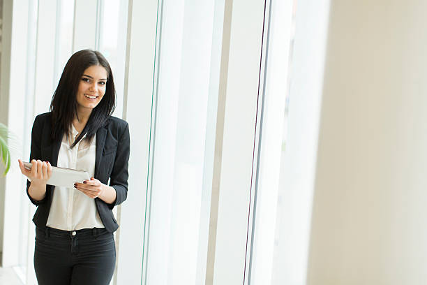 istock Young woman with tablet in the office 587807962