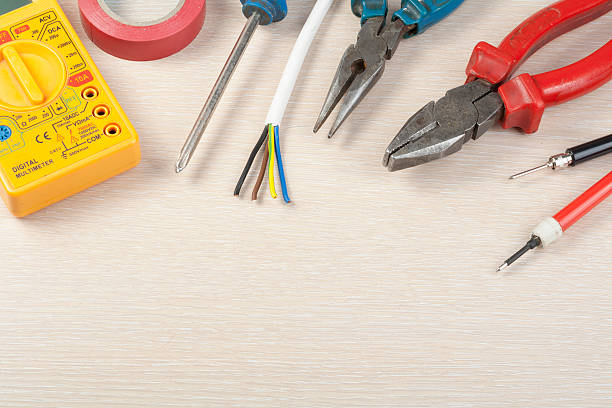 istock Set of electrical tool on wooden background. Accessories for engineering 587808158