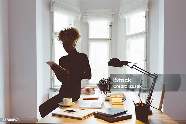 Afro American Woman Using A Digital Tablet In An Office Stock Photo - Download Image Now