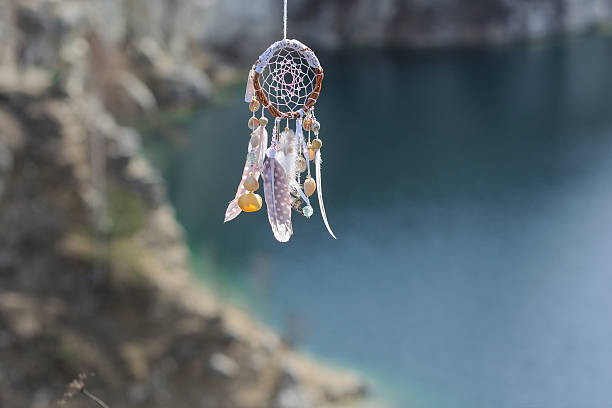 istock Handmade native american dream catcher on background of rocks an 587809372