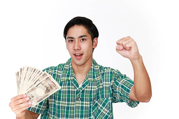 istock Smiling Asian man with money 587809650