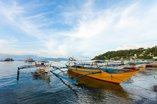 Puerto Galera, Philippines - May 15, 2012: Boats docked in Sabang Beach in Puerto Galera, Philippines.