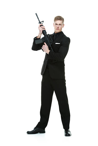 istock Businessman in action with rifle 587810028