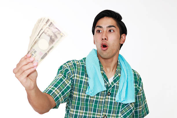 istock Surprised Asian man with money 587810424