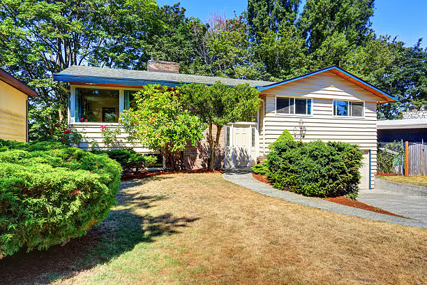 istock Small cute American house with green shrubs. 587812246