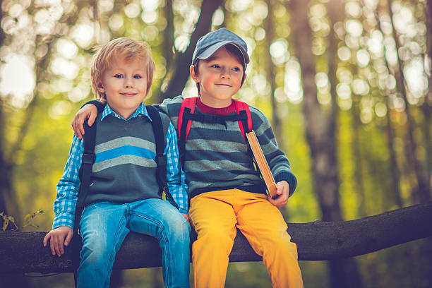 istock Little schoolboys in autumn 587812288